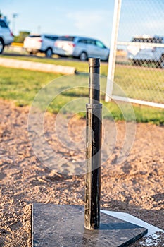 Tee ball stand at home plate used for youth baseball.