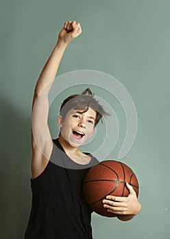 Teeb boy with basketball ball score goal gesture