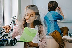 teen african american schoolgirl with notebook on stem