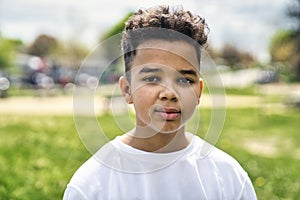 Teen afro american boy in the garden on the day time
