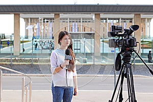 Teen age girl reporter talking in front of knesst
