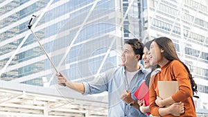 teen asia people use smart phone to selfie, self-portrait photography shoot, held in the hand and supported by a selfie stick