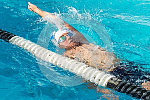 Teen backstroke swimmer in action. photo