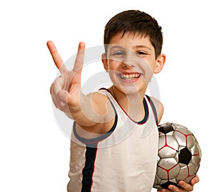 Teen with a ball showing a victory sign