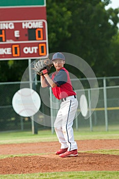 Teen baseball boy ready pitch from the mound.