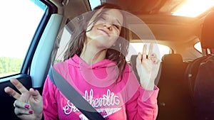 Teen beautiful girl sings and dances in the car on the sunshine background. 3840x2160