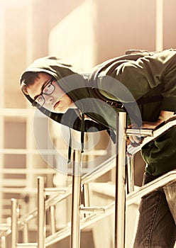 Teen boy with backpack against a school building