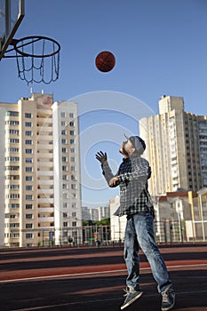 Teen boy basketball player in action in a basketball court