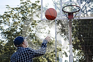 Teen boy basketball player in action in a basketball court