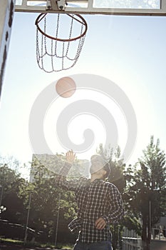 Teen boy basketball player in action in a basketball court