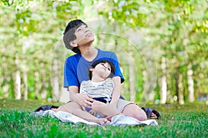 Teen boy caring for disabled brother