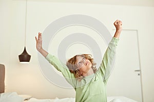 Teen boy child stretch wake up from sleep