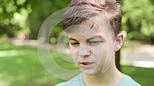 Teen boy in city park