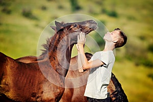 Teen boy communicates with horses