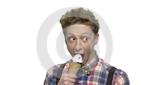 Teen boy eating ice cream on white background.