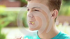 Teen boy eating sandwich