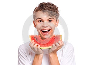 Teen boy eating watermelon