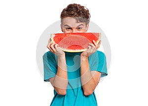 Teen boy eating watermelon