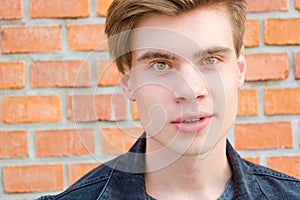 Teen boy face portrait showing expression of curious smile