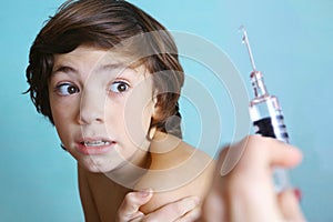 Teen boy in fear of injection.