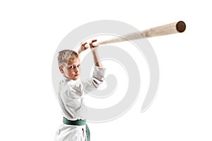 Teen boy fighting with wooden sword at Aikido training in martial arts school