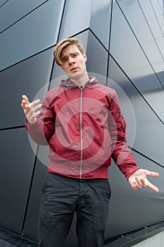 Teen boy gesticulating to express doubt about decision photo