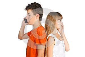 Teen boy and girl chatting on cell phones