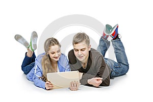 Teen boy and girl sitting with tablets