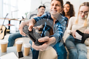 teen boy hardly playing video game