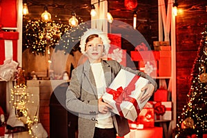 Teen boy help santa with presents. visit santaland this holiday. winter wonderland in north pole. small boy celebrate