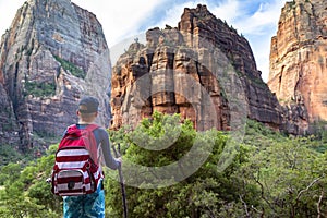 Teen boy hiking through scenic canyons at Zion National Park photo