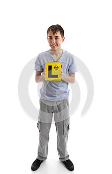 Teen boy holding L learner plates