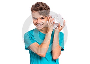 Teen boy holding piggy bank