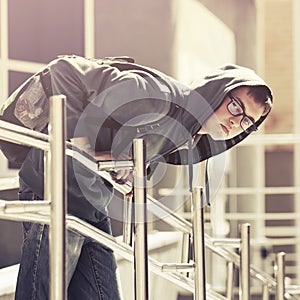 Teen boy in a hoodie in city street