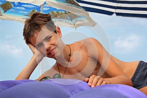 Teen boy on inflatable mattress