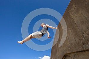 Teen Boy Jumping Blue Sky