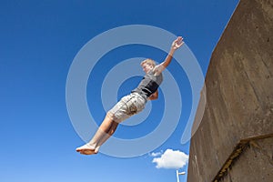 Teen Boy Jumping Blue Sky