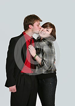 Teen boy kissing girl on cheek