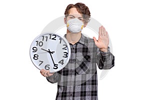 Teen boy in mask with clock