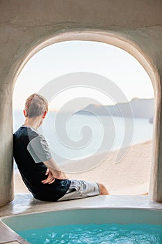 Teen boy in Oia village on Santorini island