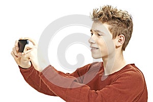 Teen boy photographing with a smartphone photo