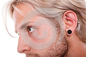 Teen boy with piercing and fashionable hairstyle photo