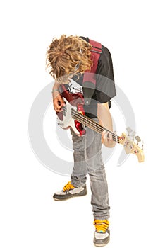 Teen boy playing bass guitar