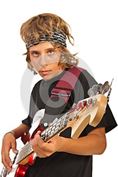 Teen boy playing bass guitar