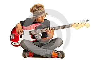 Teen boy playing bass quitar