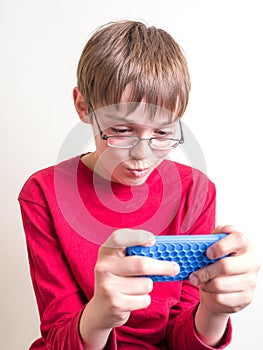 Teen Boy Playing with Cell Phone