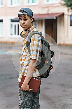 Teen boy portrait on the way to school, education and back to school concept