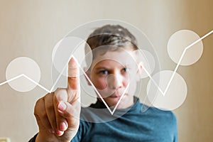 Teen boy shows his finger at an imaginary screen