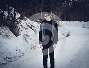 Teen Boy Standing on a Snow-Covered Road