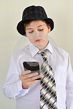 Teen boy with surprise looks at mobile phone photo